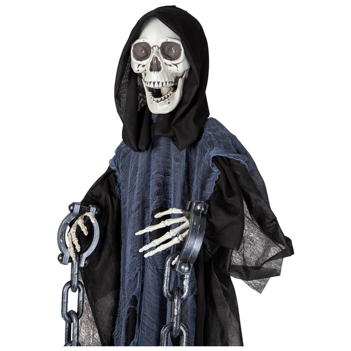 Detail of the skull and skeleton hands of a hanging grim reaper figure decoration