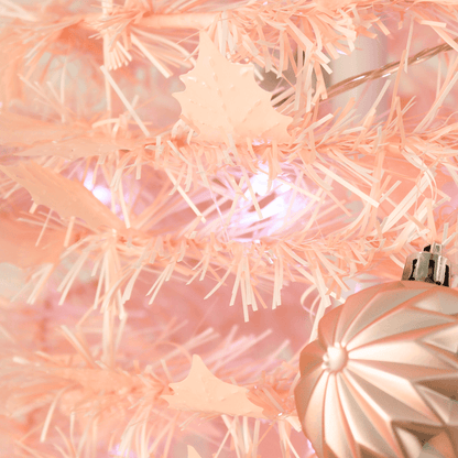 pink tinsel tree with holly shaped tinsel
