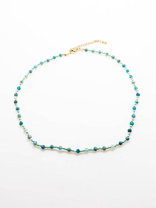 The Faye Necklace in Teal featuring apatite beads and stainless steel accents on a white background.