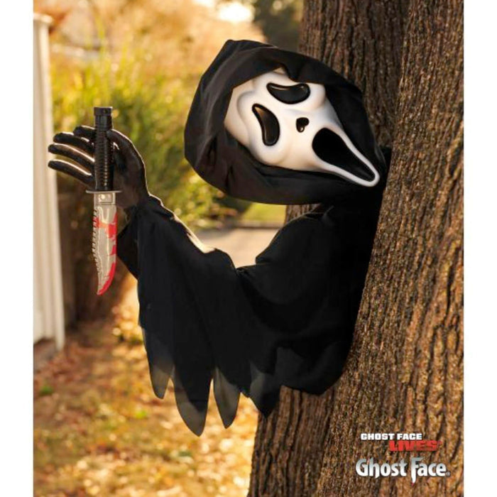 Ghost Face Halloween decoration on a tree in the garden