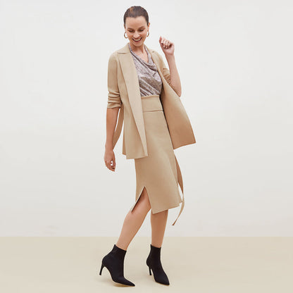 Side image of a woman standing wearing the Harlem skirt in latte