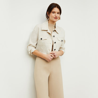 Front image of a woman standing wearing the Malki top in latte