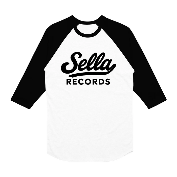 A white and black raglan-sleeve baseball shirt from The Front Bottoms, featuring "Sella RECORDS" in bold black letters on the front. Available for presale with preorder shipping starting 04/03/26.