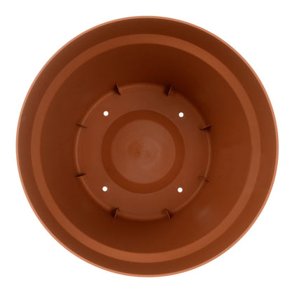 View inside of round terracotta planter with drainage holes