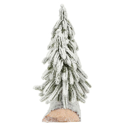 Side view of a snow flocked mini Christmas tree on a wooden log base