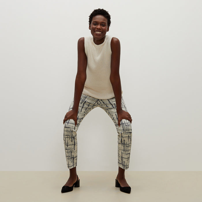 Front image of a woman standing wearing the Spardel top in ivory
