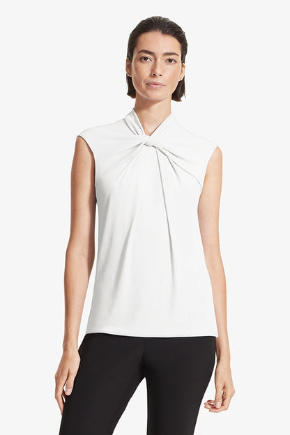 Front image of a woman standing wearing the Walters top knit crepe in Ivory | Grid | Exclude